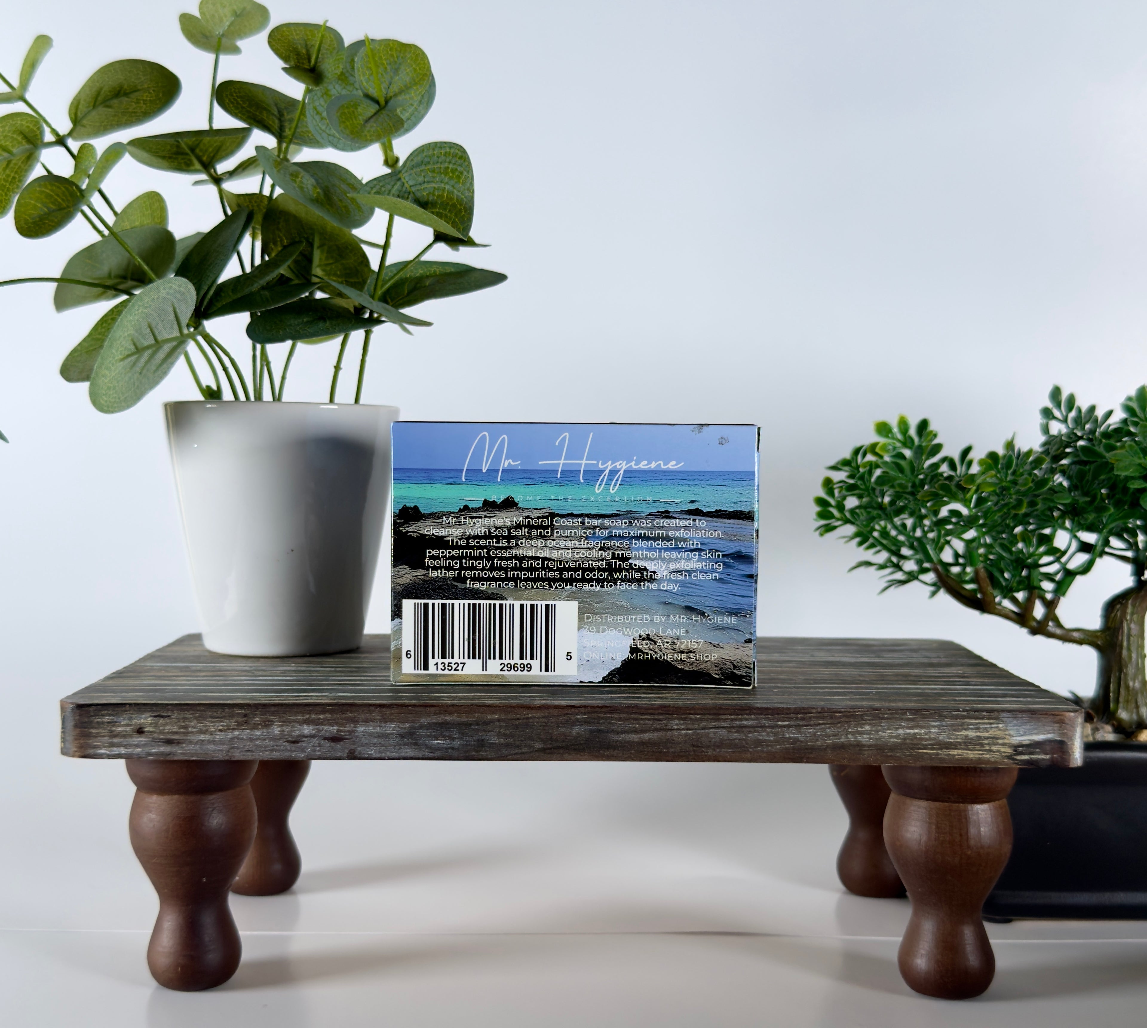 Soap on a wooden stand with plants in the background
