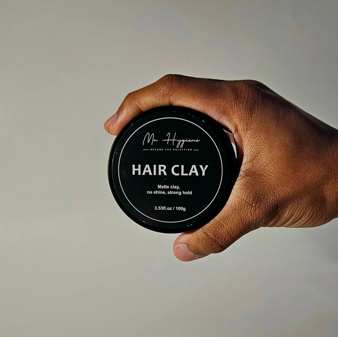 Matte Hair Clay Tin in hand