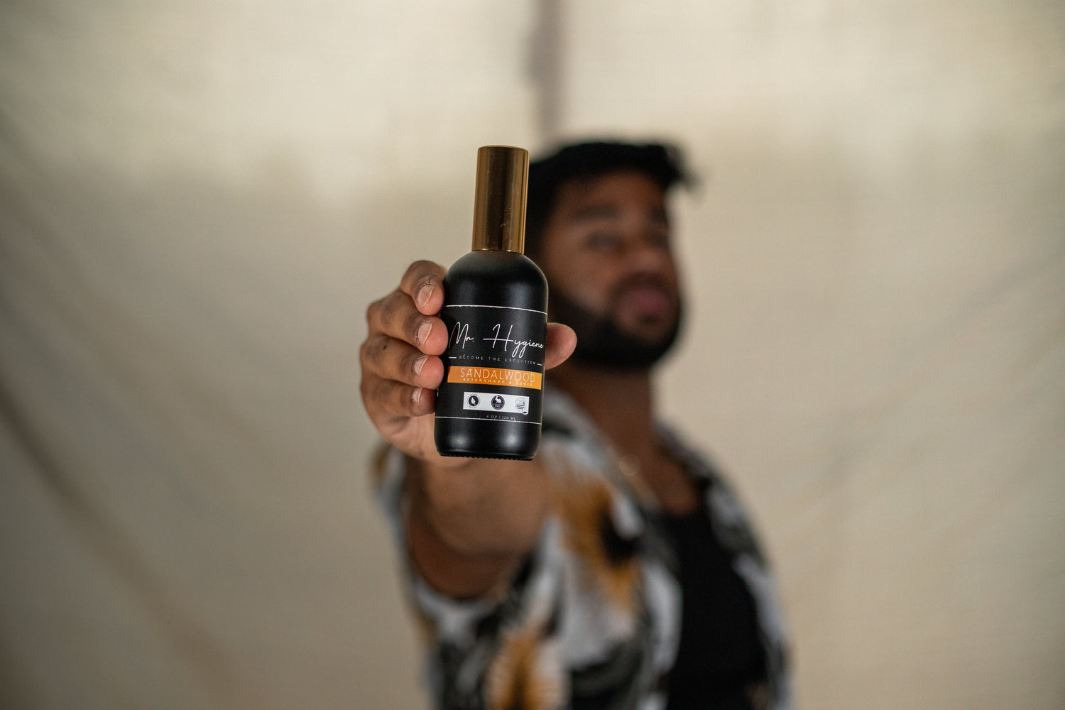 guy holding out a sandalwood aftershave