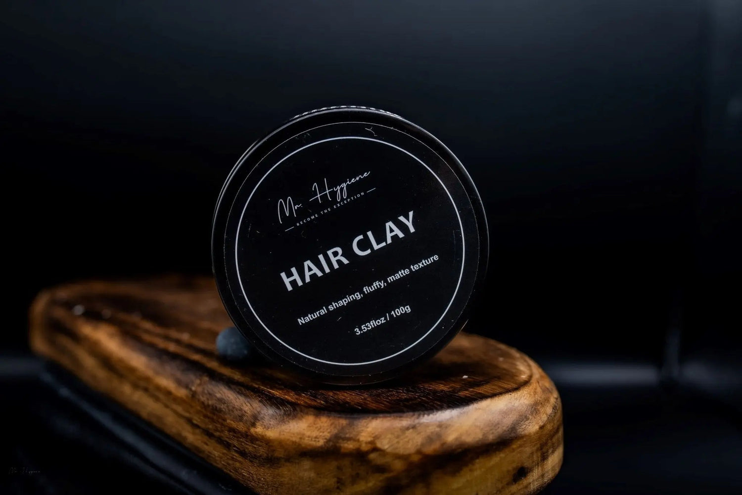 Mens Hair Clay in a sleek container for strong, natural-looking hold