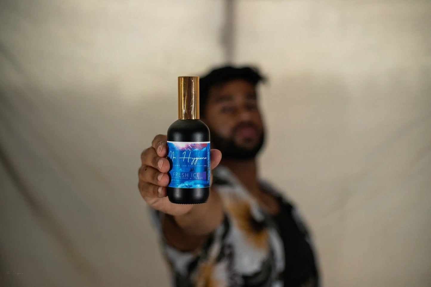 guy holding bottle of fresh ice aftershaves