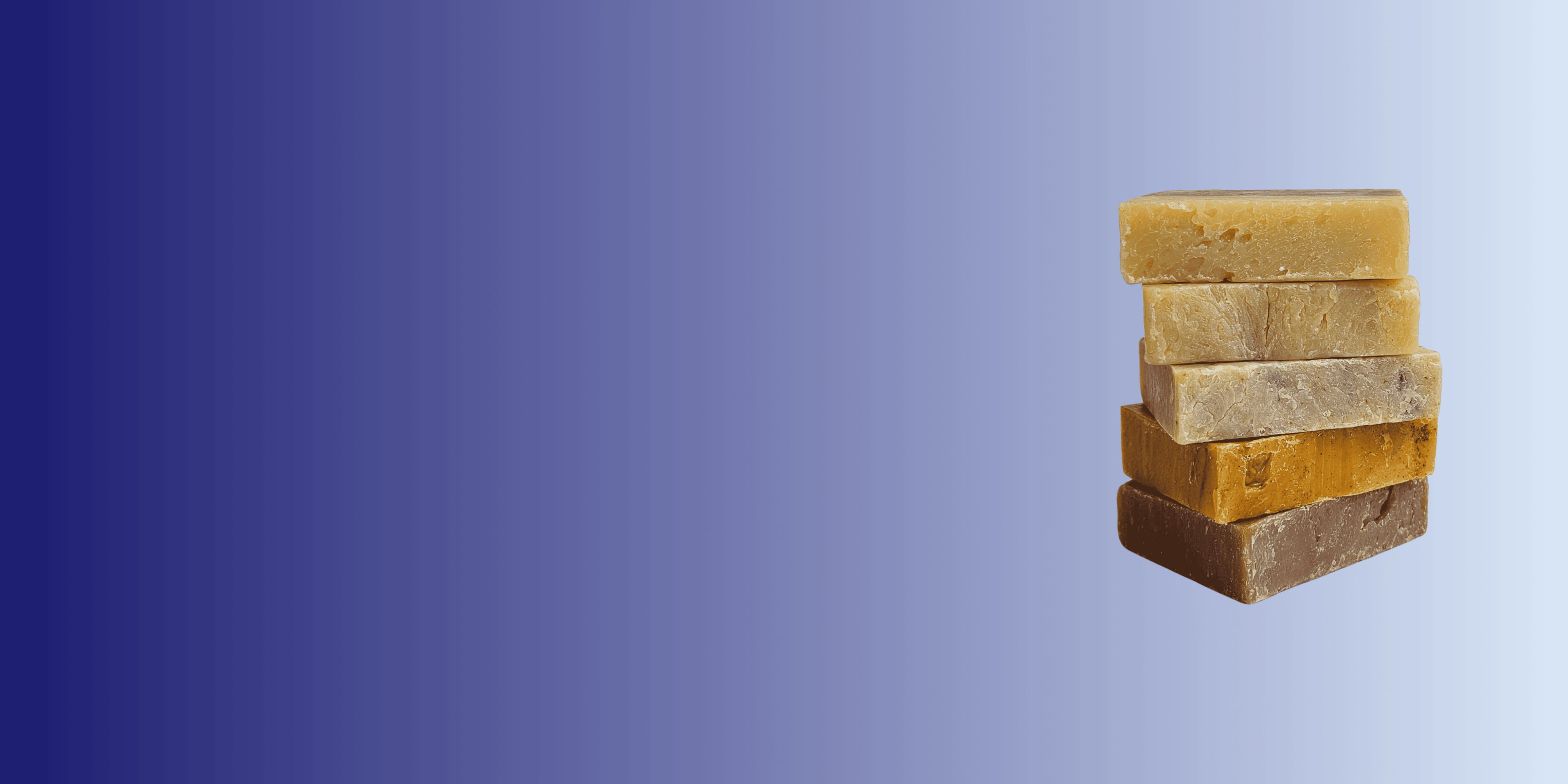 Stack of five rectangular soap bars on a gradient blue background